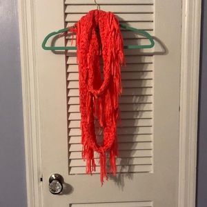 Hot pink scarf with fringe.